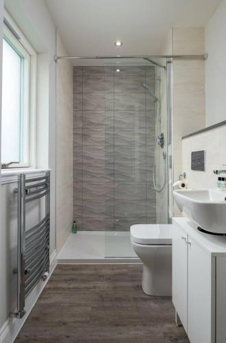 a bathroom with a shower and a toilet and a sink at Brunstane House - 15 mins to City Centre in Edinburgh