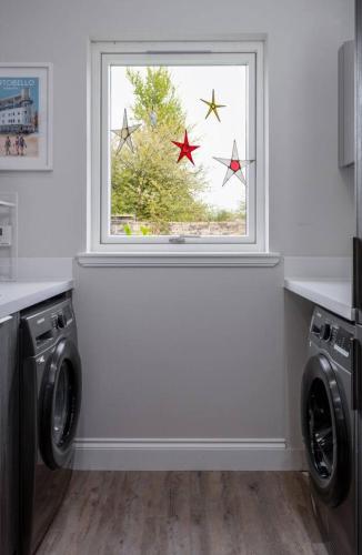 a laundry room with a window with three stars at Brunstane House - 15 mins to City Centre in Edinburgh
