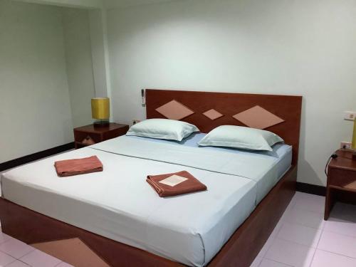 a bedroom with a large bed with two towels on it at Freedom house in Karon Beach
