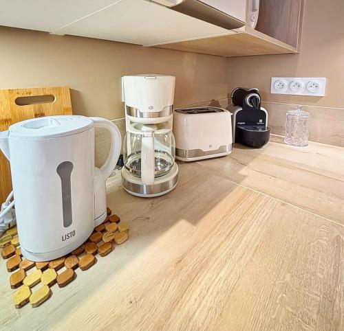 a kitchen counter with a blender and other appliances at Joli Perot in La Rochelle