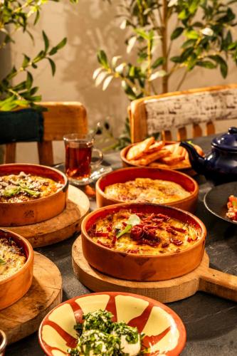 a table topped with different types of pizzas at Lacosta Hotel in Aqaba