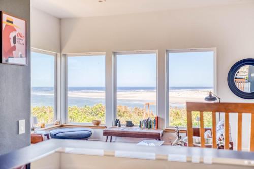 a kitchen with views of the ocean from windows at Walters Waldport in Waldport