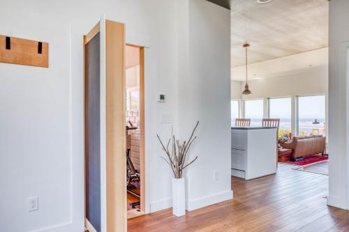 a kitchen and living room with white walls and wood floors at Walters Waldport in Waldport