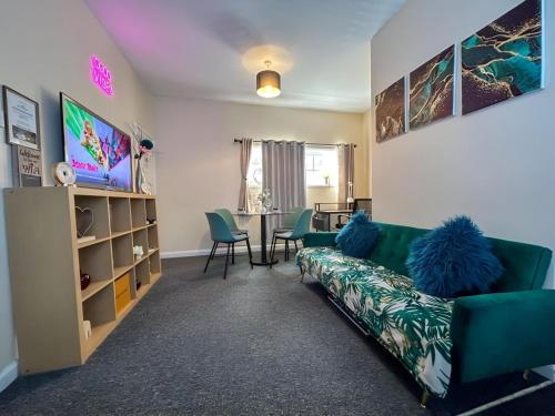 a living room with a couch and a table at Sherry's 2 Bed Guest House in Buckinghamshire