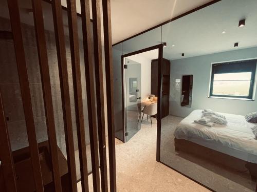 a bedroom with a mirror and a bed and a desk at Domaine Sur Les Sarts in Ohey