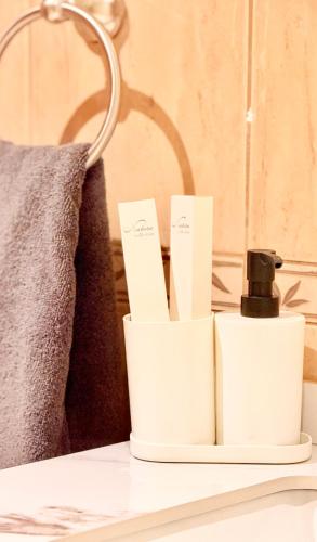 a bathroom counter with two white towels and a lamp at BEST PLACE HOLIDAY HOME ii FREE PARKING in Ajman 