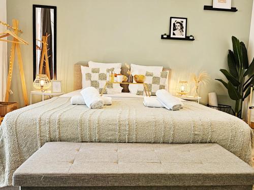 a bedroom with a large bed with two pillows at Le refuge du Grand Vert in Grasse