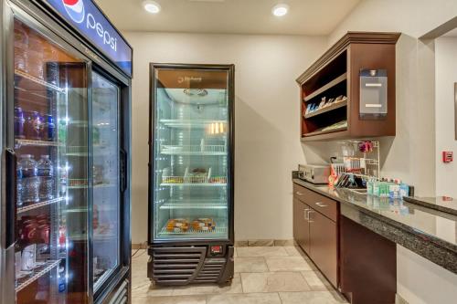 a kitchen with an empty refrigerator in a store at Comfort Inn & Suites Morgan - South Ogden in Morgan