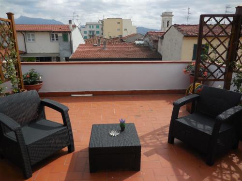 a patio with two chairs and a table on a balcony at Hotel Lupori in Viareggio