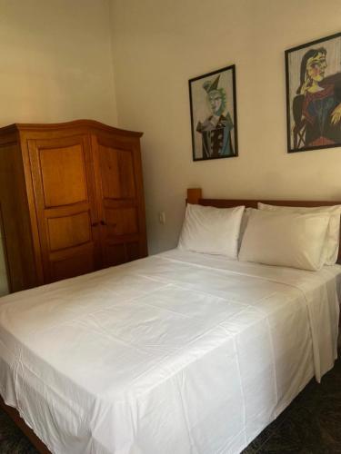 Una cama o camas en una habitación de Pousada Pouso do Sô Vigario