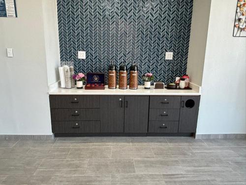 a counter with boots on it in a room at Studio 6 Suites Memphis, TN East Memphis in Memphis
