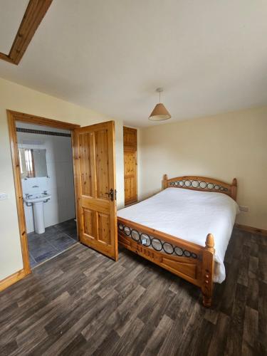 a bedroom with a bed and a bathroom at Beacon View, Church Cross, Skibbereen, County Cork in Church Cross