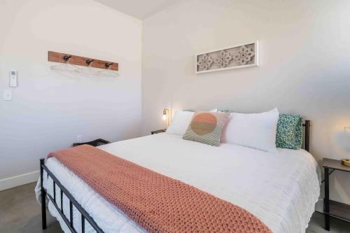 a bedroom with a large white bed with pillows at Morrison Getaway - 2BR House BBQ Free Parking in Morrison