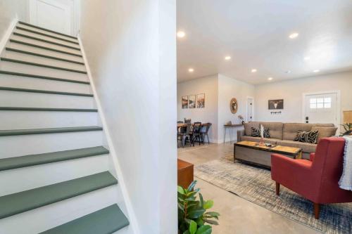 a staircase in a living room with a red chair and a couch at Morrison Getaway - 2BR House BBQ Free Parking in Morrison
