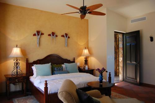 a bedroom with a bed with a ceiling fan at Villa Estero by Cabo Villas in San José del Cabo