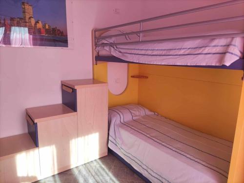 a bunk bed with two bunk beds in a room at Family house with garden in Fosdinovo