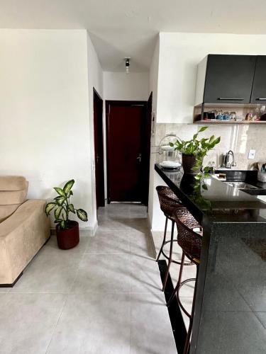 a kitchen with a counter and a sink in a room at Apartamento Próximo ao Aeroporto e Rodoviária in Palmas