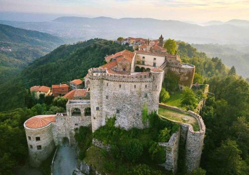 an old castle on top of a mountain at Family house with garden in Fosdinovo
