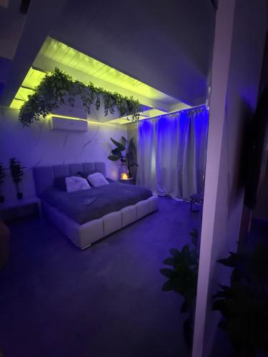 a bedroom with a bed in a room with purple lights at Spartementen by Pure-Zen in Rotterdam