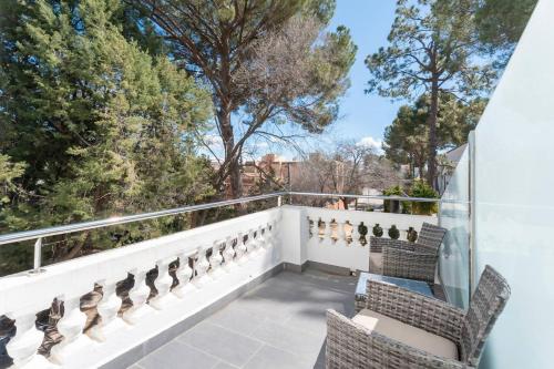 a balcony with chairs and a view of trees at 1893 Hotel Boutique in Navajas