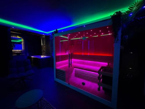 a bathroom with purple and green lights in a room at Spartementen by Pure-Zen in Rotterdam