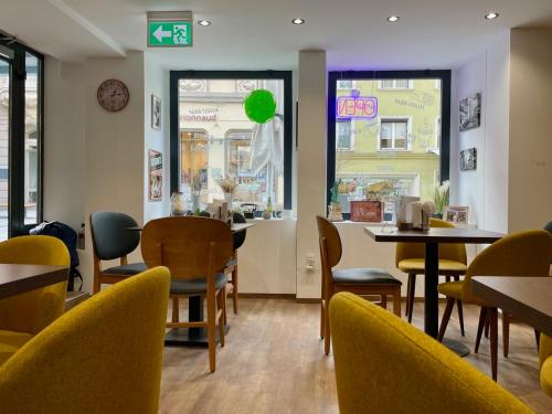 a restaurant with tables and chairs and a green balloon at Pension Sonne Bed&Breakfast in Bregenz