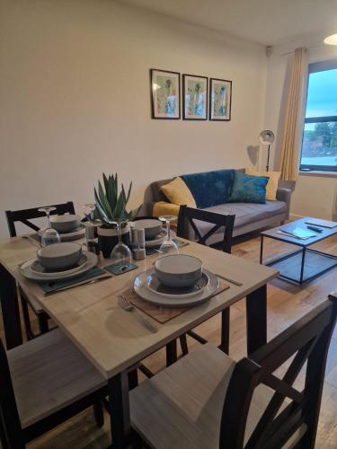 a living room with a table and a couch at Vibrant cosy 2 Bedroom Apartment in Coventry