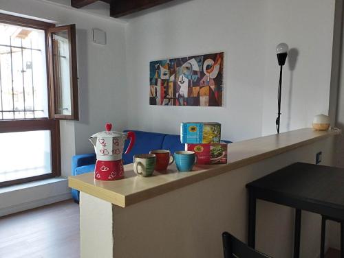 a kitchen with a counter with cups on it at Da Cocò in Udine