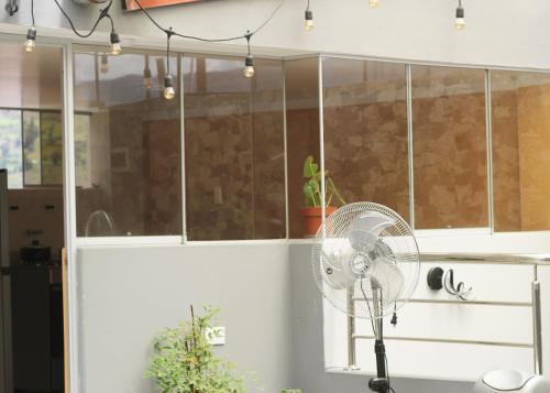 a white fan in a kitchen next to a window at Ayllu in Huaraz