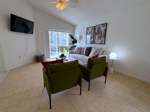 a living room with a couch and two chairs at Beautiful South-Facing Pool Home in Southern Dunes in Haines City