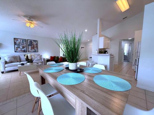 a dining room and living room with a table and chairs at Beautiful South-Facing Pool Home in Southern Dunes in Haines City