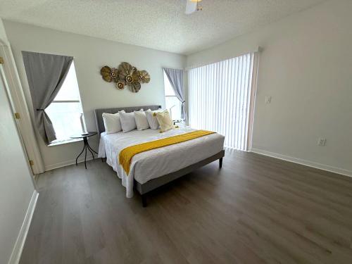 a bedroom with a bed with a yellow blanket at Beautiful South-Facing Pool Home in Southern Dunes in Haines City