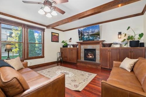 a living room with couches and a fireplace at The Fireside Retreat - 6 BD, Sauna, Home Theater in Greeley