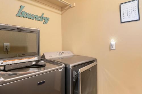 a laundry room with a washer and dryer at The Fireside Retreat - 6 BD, Sauna, Home Theater in Greeley