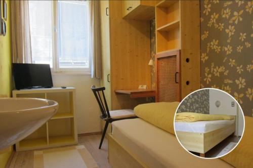 a bedroom with a sink and a bed with a mirror at Pension Sonne Bed&Breakfast in Bregenz