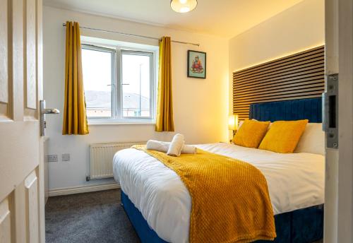 a bedroom with a bed with yellow curtains and a window at Terry Haven-2Bed,Coventry,Luxury in Parkside