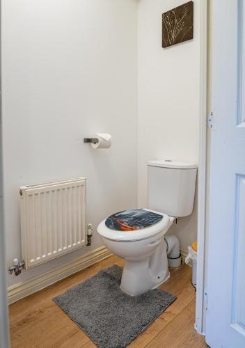 a bathroom with a toilet with a towel on it at Terry Haven-2Bed,Coventry,Luxury in Parkside