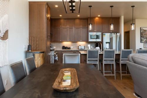 a kitchen and living room with a wooden table at Apex Manor in Winter Park