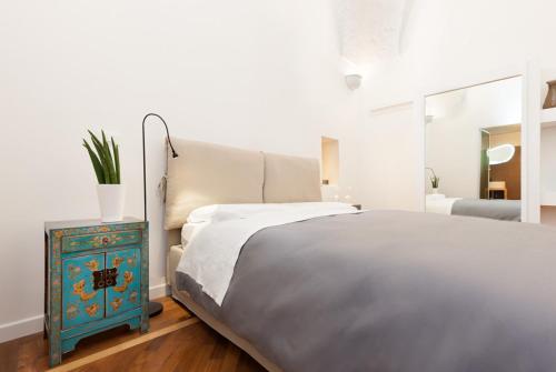 a bedroom with a bed and a blue night stand at San Matteo House in Lecce