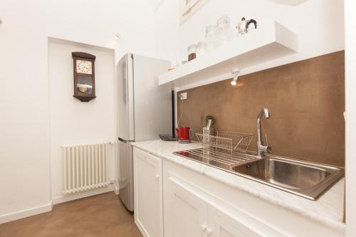 a kitchen with a sink and a refrigerator at San Matteo House in Lecce