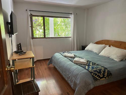Apartamentos Otorongo Cuenca Ecuadorにあるベッド