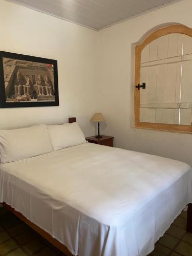 Una cama o camas en una habitación de Pousada Pouso do Sô Vigario