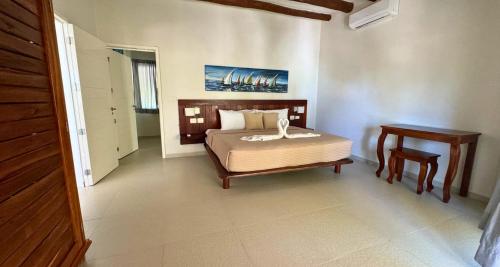a bedroom with a bed and a table in it at Spirit Holbox in Holbox Island