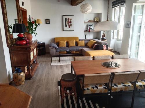 a living room with a couch and a table at Maison Haute in Moux-en-Morvan