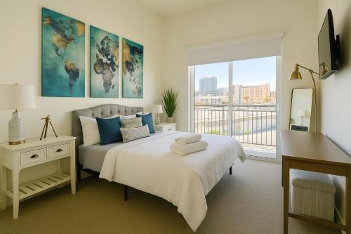 a bedroom with a bed and a large window at Fremont Experience with Pool/spa in Las Vegas