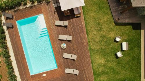 an overhead view of a swimming pool with chairs and a lawn at Villa Manù country house in Castellammare del Golfo