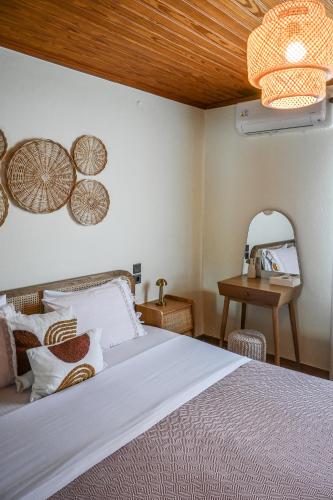 a bedroom with a bed and a wooden ceiling at Nisaki House in Skiathos