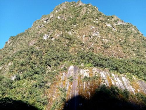 a mountain with a road on the side of it at El Quetzal MachuPicchu in Machu Picchu