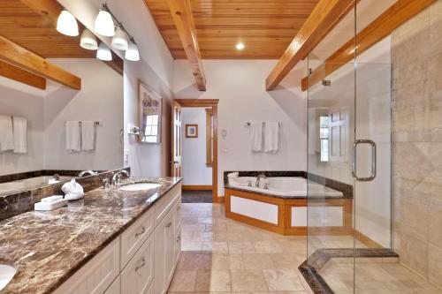 a bathroom with two sinks and a shower at Casita Alta - Woodstock, VT - Main House & Pool House with Private Heated Pool and Mountain Views in Woodstock