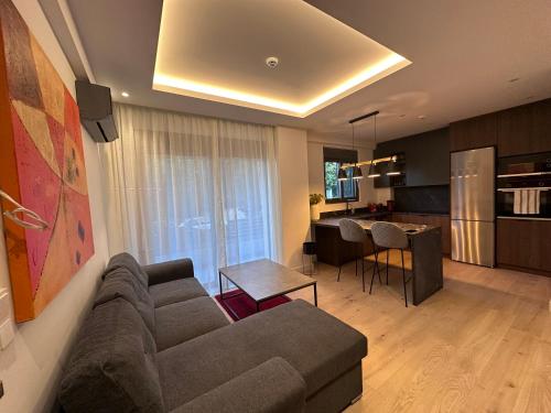 a living room with a couch and a kitchen at Alimos Escape in Mesochórion